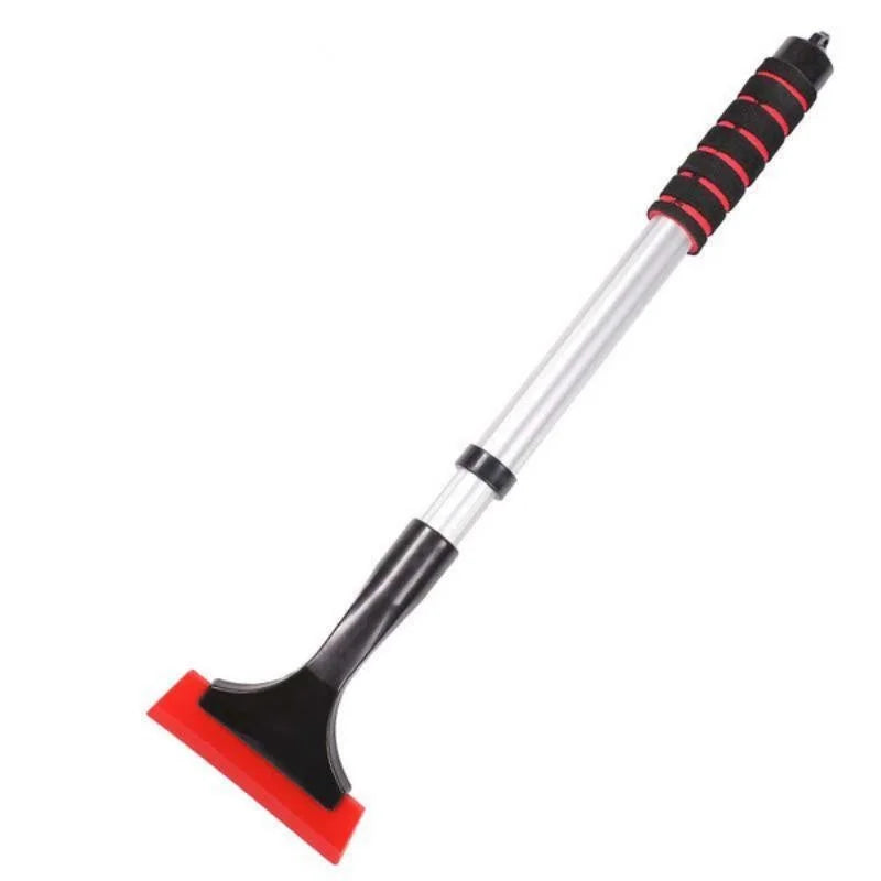 Telescopic snow brush reaching across an SUV windshield